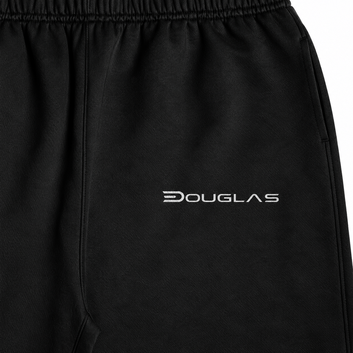Close detail of white Douglas wordmark on black heavyweight joggers