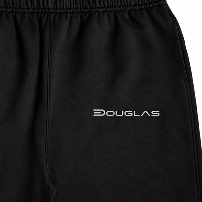 Close detail of white Douglas wordmark on black heavyweight joggers